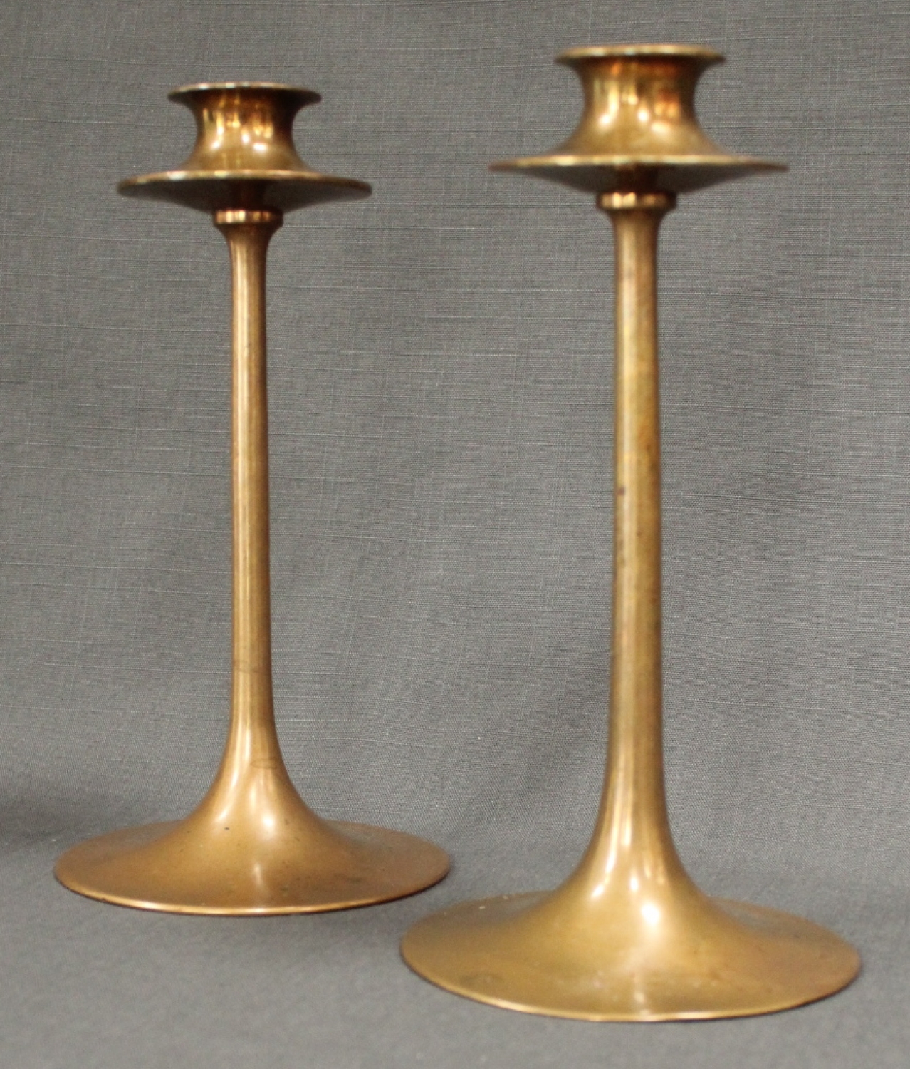 A pair of Arts & Crafts bronze candlesticks