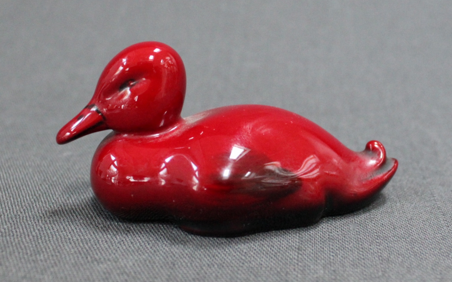 A Royal Doulton Flambe seated duck